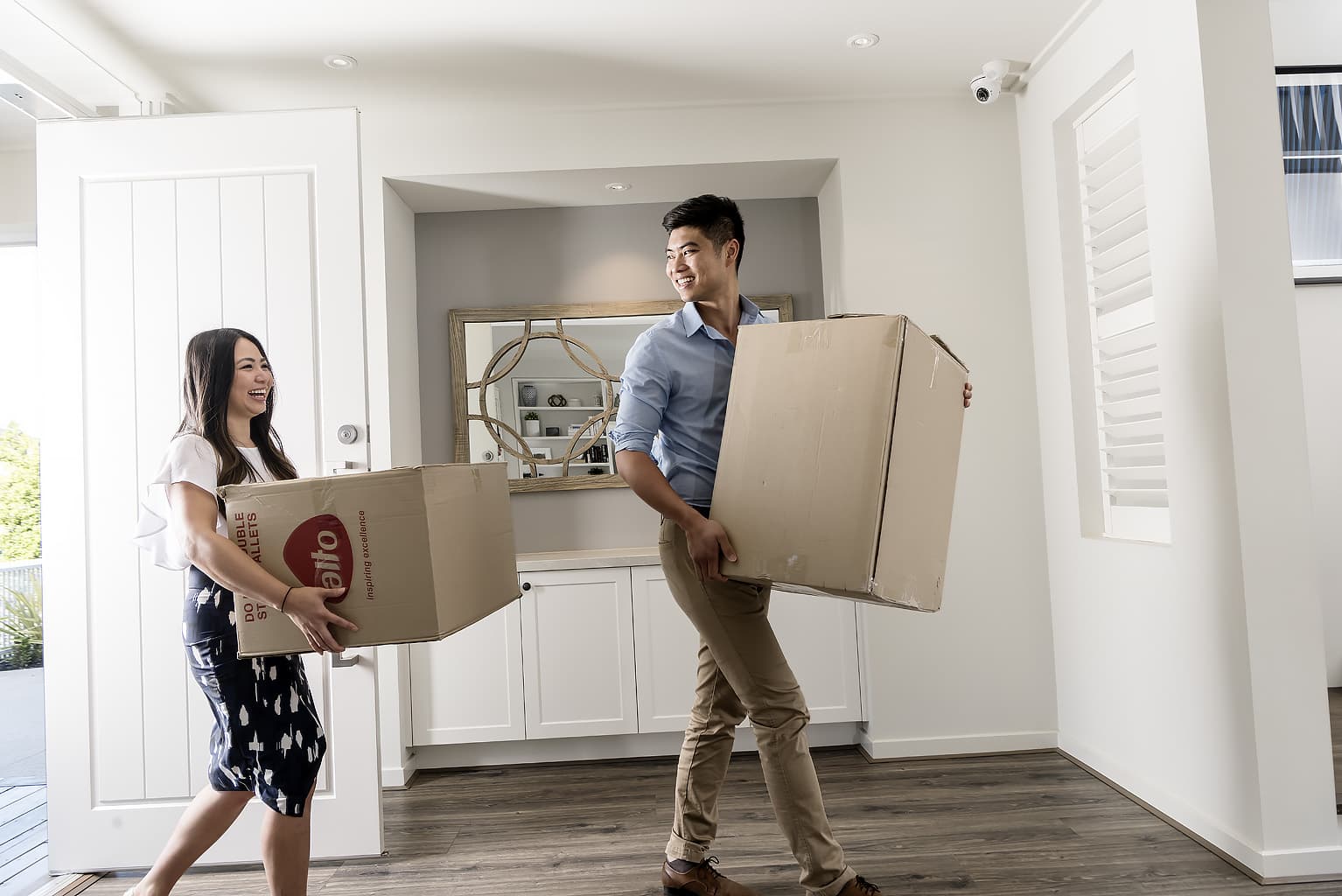 Couple moving in, boxes, hallway